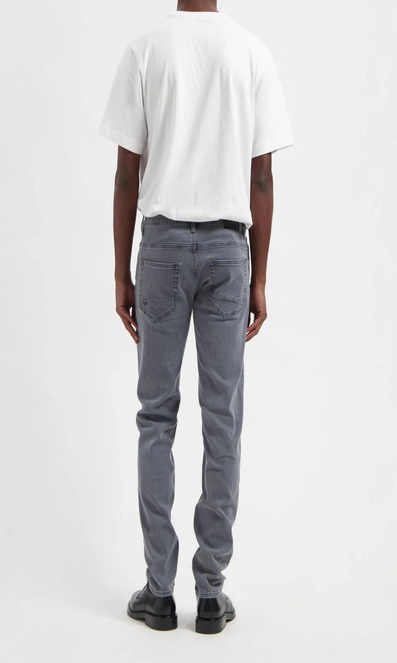 Person wearing gray jeans and a white t-shirt on a white background